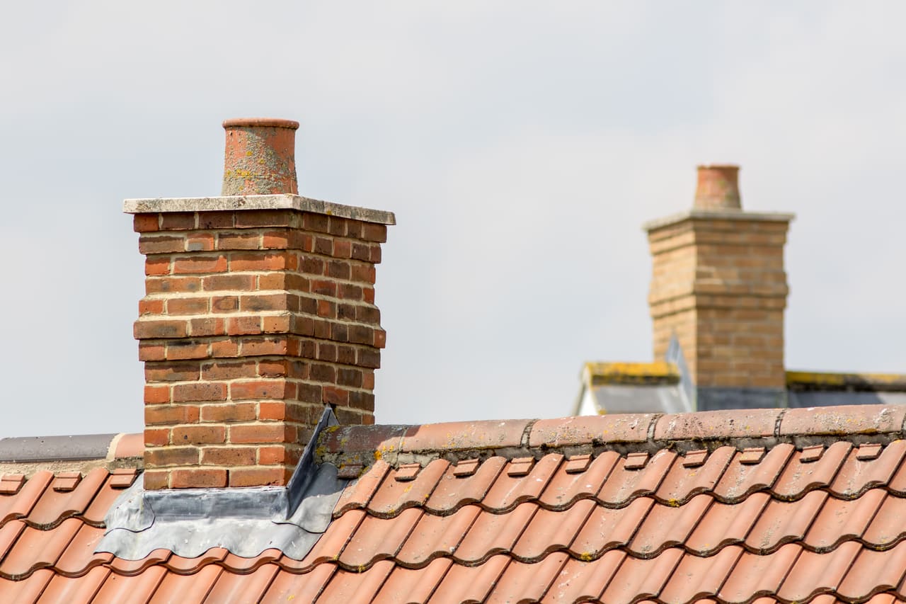 Roofer repairing a brick chimney stack in Berkshire